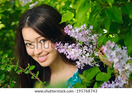 Beautiful Asian woman with lilac flower