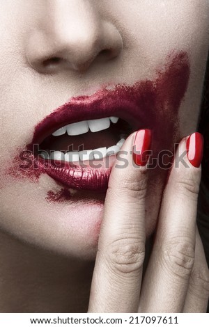 Sensual woman sexy posing. Face close up with red  smeared lips and nails. White skin