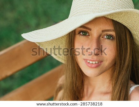 Young beauty woman head shot over grass background