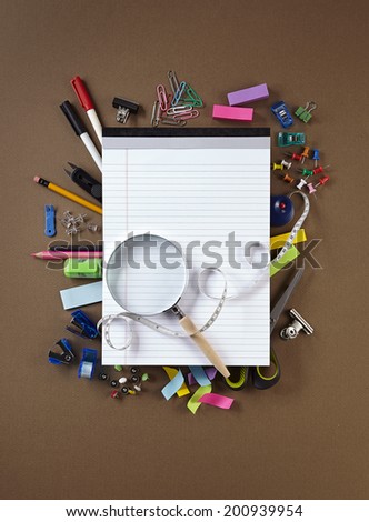 Photo of office and student gear over brown background - Back to school concept