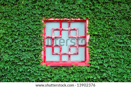 Red square window of Chinese traditional style in green leaves
