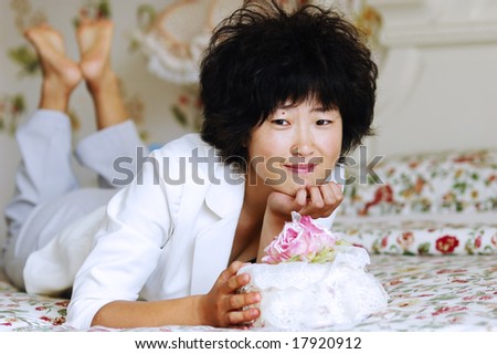 Chinese girl thinking on bed