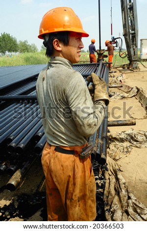 SHENGLI OIL FIELD,DONGYING,CHINA - JUNE 5: Petroleum workers working in the field June 5,2008 in Dongying,China.