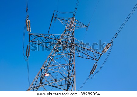Electric power pole against blue sky