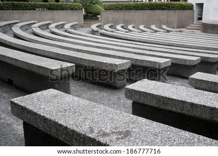 row of stone bench in stadium