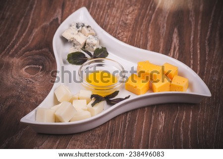 cheese platter with jam on white plate