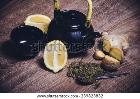 green tea with lemon and ginger with tea cup and teapot
