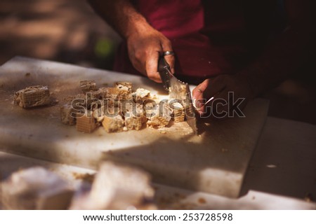 men cutting italian sweets on market no face