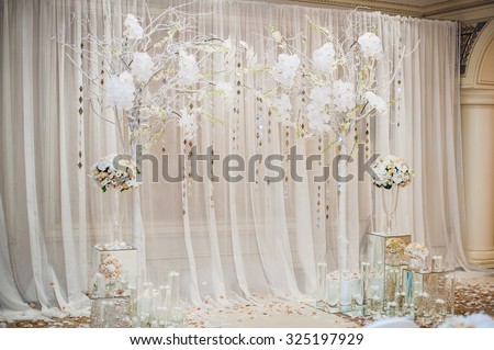 Beautiful wedding ceremony design decoration elements with arch, floral design, flowers, chairs indoor