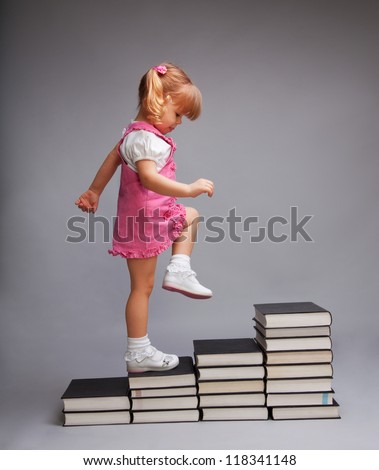 Successfully going from one education level to another - girl going up the stairs of books