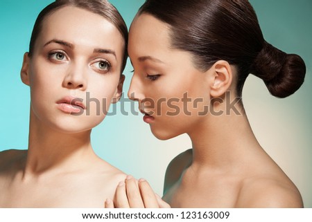 Sensual clean beauty portrait of two women with Asian and Caucasian appearance