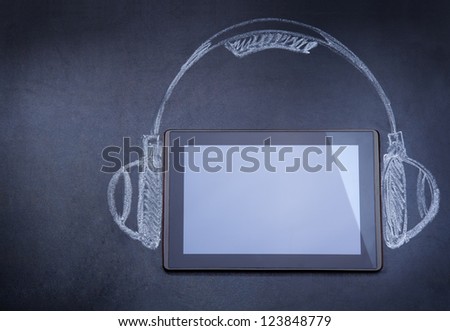 Tablet computer as audio player on the blackboard with tripod and strobe drawn with chalk