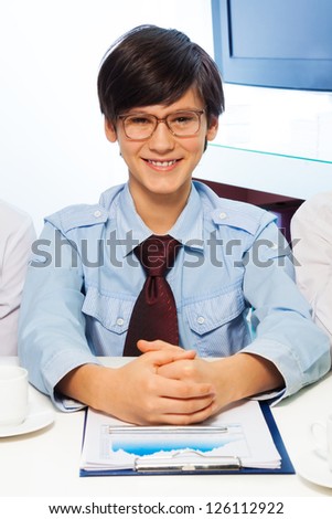 Teen kid pretending to be a big grown up adults and work in office
