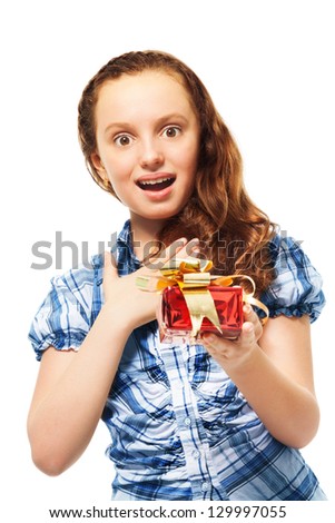Happy surprised teen Caucasian girl holding small red present box with gold bow