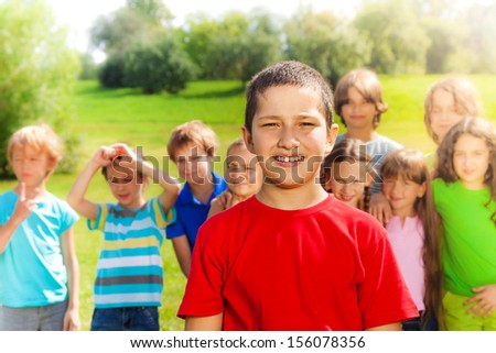 Happy group of people and close portrait one Asian boy in red shirt