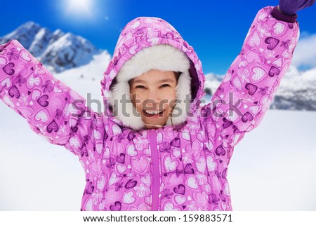 Close up portrait of happy Caucasian girl with lifted from excitement hands on snow outside in winter