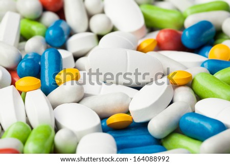 Close-up of pile of drugs, many different pills and tablets of different color blue, red, yellow