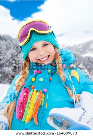 Close portrait of happy smiling Caucasian girl standing outside with snow-skates