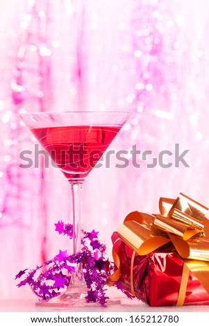 Cocktail glass with alcohol cocktail with festive Christmas decoration  and sparkling background