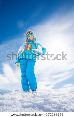 Happy smiling Caucasian girl standing outside with snow-skates