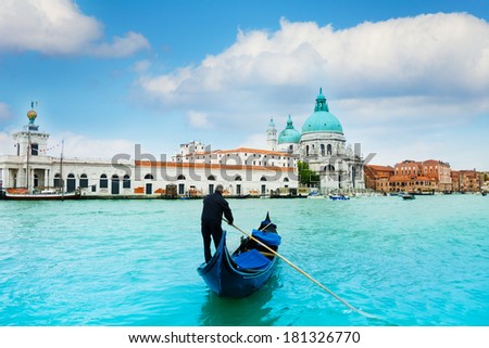 Santa Maria della Salute Basilica in Venice with gondola and gondolier in central Venice, Italy