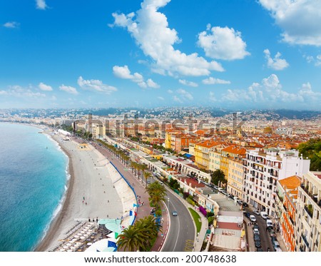 Luxury resort of French Riviera, main street of Nice city in France with beach, shops and palms on sunny summer day
