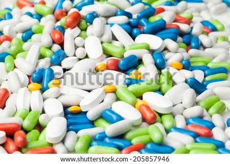 Pile of drugs, many different pills and tablets of different color blue, red, yellow
