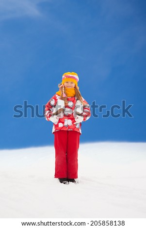Happy smiling little Caucasian girls standing outside in snow with ice-skates