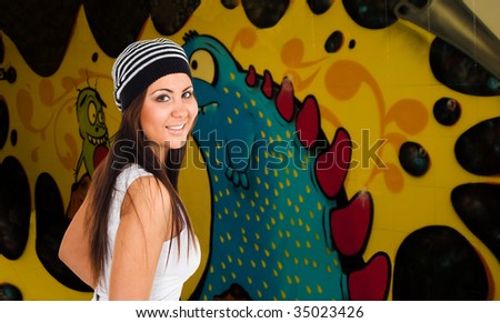 Smiling young woman with graffiti on background