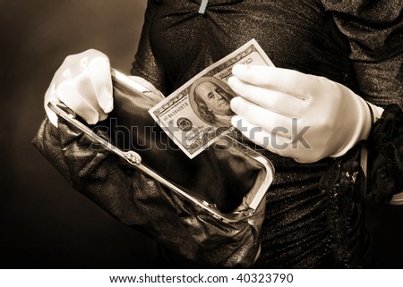 Woman in put cash in wallet wearing white gloves