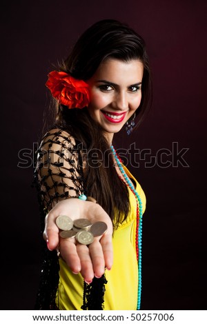 gypsy woman offer money drawing out palm with coins