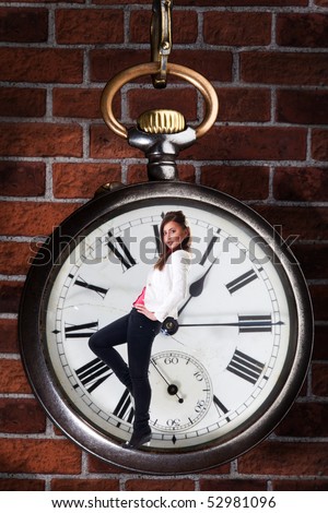 Young woman inside old style clock representing age concepts
