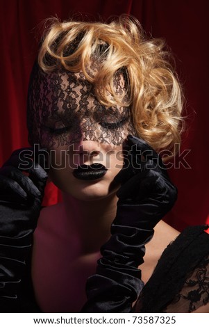 Dreaming about love - beauty portrait of a woman with curly and blond hair and vial bandage on face with professional make up and hair style