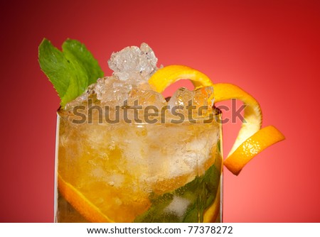Fresh orange drink with ice, orange and mint in glass