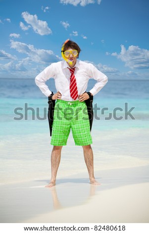 Business man wearing white shirt  and tie and also scuba, mask and holding flippers on the beach in angry pose