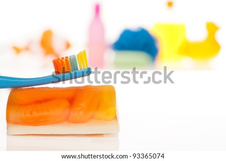 Kid\'s tooth brush with toys, soap and mop on the background