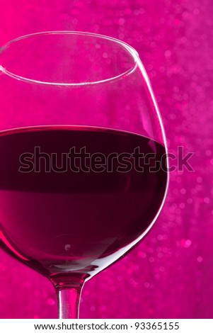 Glass of wine on sparkling purple background