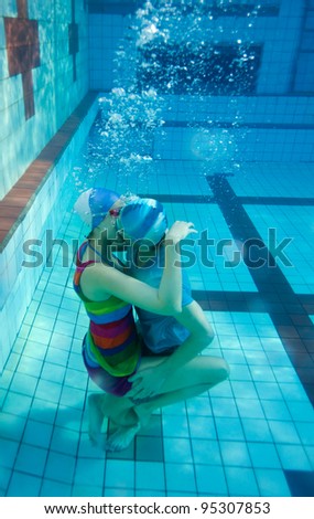 Young couple kissing underwater in the pool