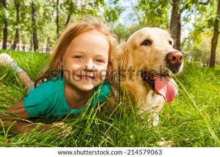 Little blond girl with her retriever dog