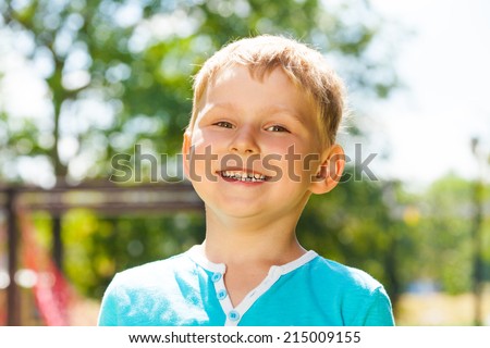 Little boy portrait with big smile outside