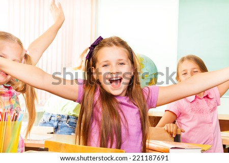 Happy Girl with arms apart laughs during lesson