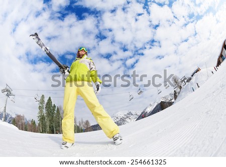 Cool girl in mask standing and holding ski