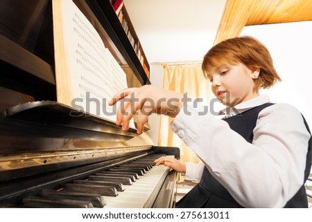 Close-up view of hands playing girl on the piano