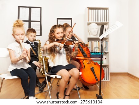 Cheerful children playing musical instruments