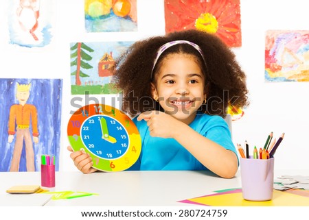 African girl holding carton clock time
