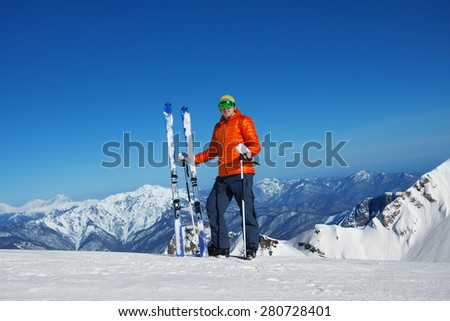 Man in ski mask standing alone and beautiful mountain view on background in sunny weather on Krasnaya polyana, Sochi