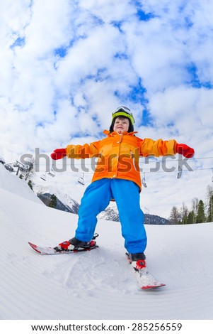 View from below of boy wearing ski mask and helmet skiing on Sochi ski resort Krasnaya polyana in Russia