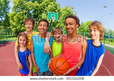 Basketball teenage team standing close after game