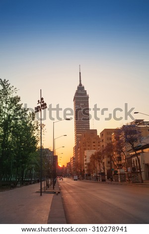 Juarez Avenue towards Latin America tower in Mexico downtown in sunrise summer sun