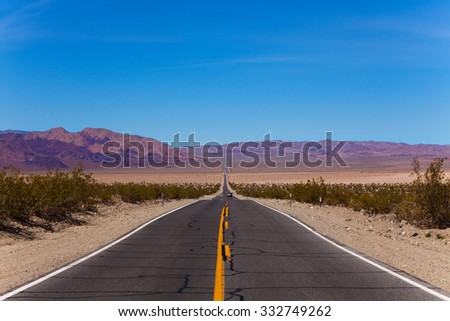 Cracked road during day in desert, California